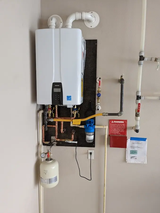 Professional plumber installing copper piping in a Moraine home